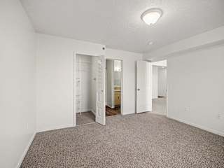 Empty bedroom with walk-in closet and double doors at Brentwood Park Apartments, La Vista, 68128