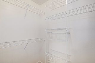 White wire shelving closet with storage baskets at Brentwood Park Apartments, La Vista