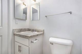 Bathroom vanity with granite countertop and medicine cabinet at Brookside Apartments, Springfield, 49037