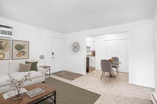 Furnished living and dining area with neutral decor at Brookside Apartments, Springfield, Michigan