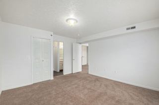 Carpeted bedroom with ensuite bathroom and closet doors at Black Sand Apartments Homes, Nebraska