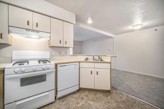 a kitchen with a breakfast bar at Canal 2 Apartments in Lansing, MI