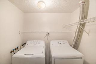a laundry room with full size washer and dryer at Canal 2 Apartments in Lansing, MI