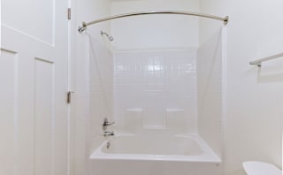 A bathtub and shower at Chase Creek Apartment Homes, Alabama, 35811