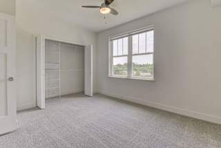 A spacious bedroom with a closet with organizers at Chase Creek Apartment Homes, Huntsville, 35811