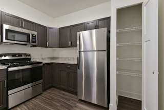 A modern kitchen with a pantry at Chase Creek Apartment Homes, Huntsville, AL, 35811