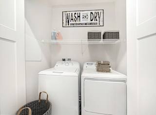 A laundry room with a full size washer and dryer at Chase Creek Apartment Homes, Huntsville, 35811