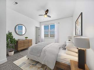 Furnished bedroom with wood furniture and ceiling fan at Chase Creek Apartments Homes, Huntsville