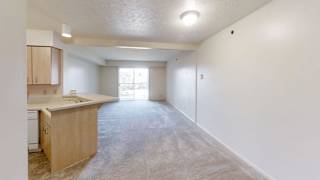 Open living space with kitchen peninsula and patio access at Colonial Pointe at Fairview Apartments, Bellevue