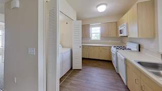 A kitchen with wooden cabinets and white appliances at Colonial Pointe at Fairview Apartments, Bellevue