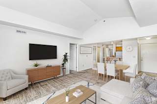 Open concept living and dining area with vaulted ceiling at Colonial Pointe at Fairview Apartments, Nebraska
