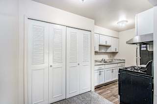 An upgraded kitchen with white cabinets and stainless steel appliances at Concord Place Apartments, Kalamazoo, MI