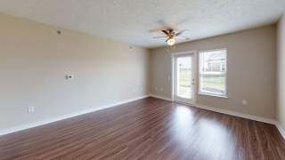 Two bedroom living room with hard surface flooring at Copper Creek Apartment Homes, Maize
