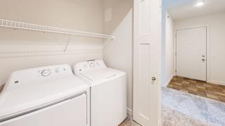 a laundry room with washer and a dryer at Copper Creek Apartment Homes in KS 67101