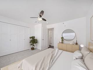 Bright bedroom with vaulted ceiling and ceiling fan at Copper Creek Homes Apartments, Kansas