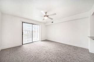 Large living room with ceiling fan at The Crossings Apartments, Grand Rapids, MI, 49508
