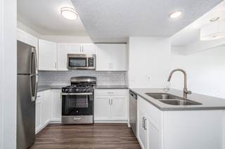 kitchen with white cabinets and stainless steel appliances at The Crossings Apartments, Michigan, 49508