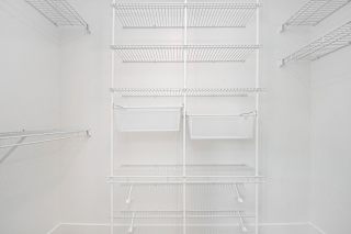 A walk-in closet with wardrobe organizers at The Crossings Apartments, Grand Rapids