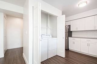 A laundry room with a full-size washer and dryer at The Crossings Apartments, Grand Rapids