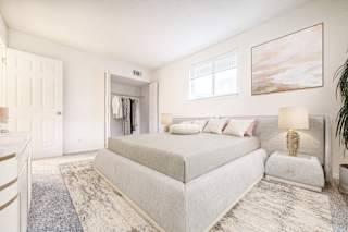 a bedroom with a bed and a dresser at Timberbrook Apartments, Peoria, Illinois