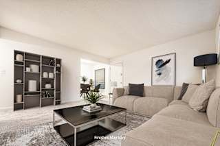 a living room with a couch coffee table and a bookshelf at Timberbrook Apartments, Peoria, Illinois