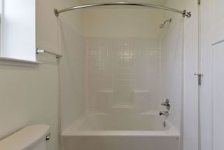 A shower and bathtub combination at Dodson Pointe Apartment Homes, Rogers, AR