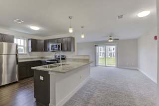 End style dining and living room leading to a modern kitchen at Dodson Pointe Apartment Homes, Arkansas, 72758