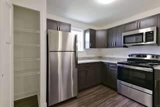 End kitchen with a window and pantry at Dodson Pointe Apartment Homes, Rogers, AR