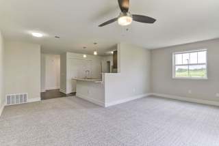 An enlarged living room with plush carpeting at Dodson Pointe Apartment Homes, Arkansas