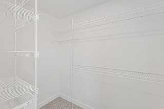 Bedroom with walk in closet with wardrobe organizers at Eagle Ridge Apartment Homes, Traverse City
