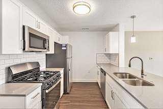 A kitchen with a white shaker-style cabinets at Eagle Ridge Apartment Homes, Traverse City, MI 49685