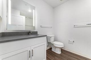 A bathroom with a large vanity and mirror at Eagle Ridge Apartment Homes, Traverse City, Michigan