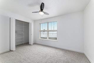Bedroom with large closet and window at Eagle Ridge Apartment Homes, Traverse City