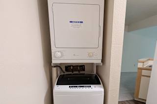 Stackable washer and dryer in laundry closet at Emerald Park Apartments, Kalamazoo, Michigan