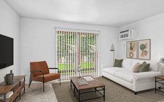 A living room with a slider to a balcony at Glen Oaks Apartments, Michigan, 49442offee table.