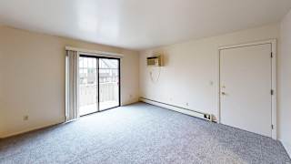 A living room with plush carpet at Glen Oaks Apartments, Michigan, 49442
