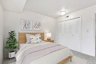 A bedroom with a large closet at Granada Apartments, Jackson, 49202