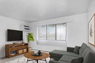 A garden style living room leading to a balcony at Granada Apartments, Jackson, 49202