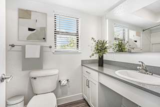 a bathroom with a toilet and a window at Green Ridge Apartments, Grand Rapids, MI