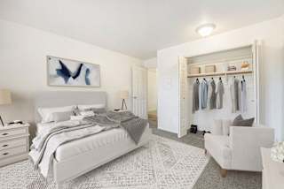 a bedroom with a large closet at Hampton Lakes Apartments in Walker, MI 49534