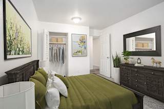 A bedroom with a large closet at Hampton Lakes Apartments, Michigan, 49534
