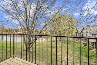 a balcony view with trees and a pond at Hampton Lakes Apartments, Michigan, 49534