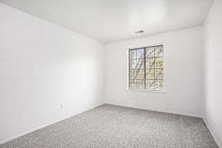 an bedroom with a large window at Hampton Lakes Apartments, Michigan, 49534