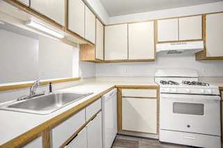 a kitchen with white appliances at Hampton Lakes Apartments, Michigan, 49534