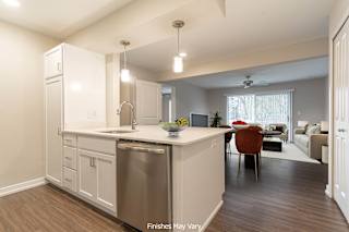 a kitchen and living room in a 555 waverly unit at Hillside Apartments, Michigan