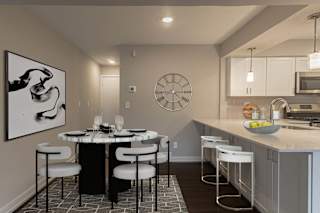 a kitchen with a large center island with a breakfast bar at Hillside Apartments, Wixom, 48393