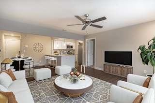 a living room filled with furniture and a flat screen tv at Hillside Apartments, Wixom