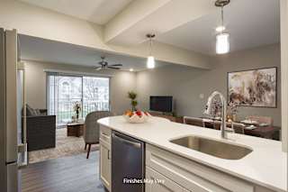a kitchen and living room with a large window and a ceiling fan at Hillside Apartments, Michigan