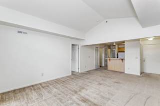 A living room with a cathedral ceiling at Limestone Creek Apartment Homes, Alabama, 35756