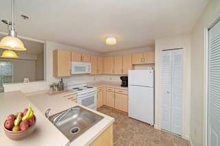 a kitchen with white appliances and a pantry at Limestone Creek Apartment Homes, Alabama